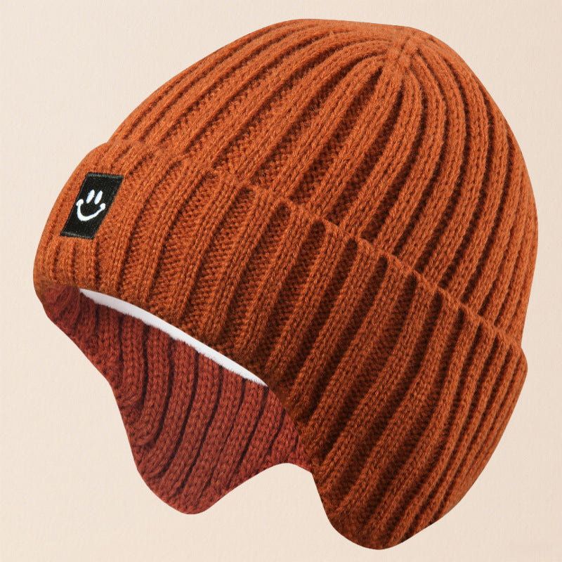 Gorro cálido de esquí con orejeras y cara sonriente para niños